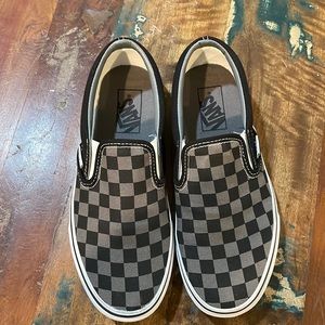 Vans black checkered slip on shoes.